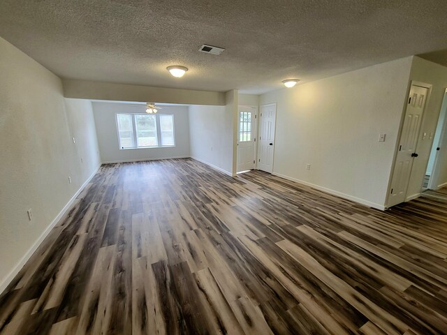 spare room with dark hardwood / wood-style flooring and a textured ceiling