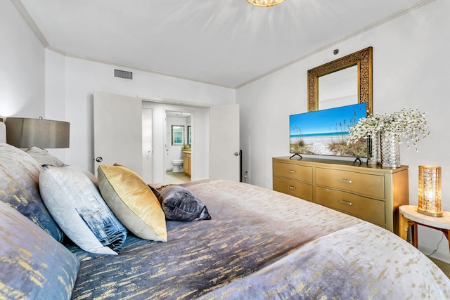 bedroom featuring connected bathroom and crown molding