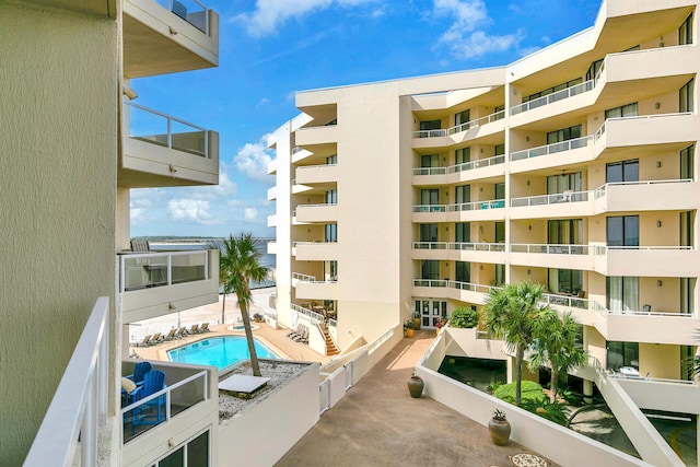 view of building exterior featuring a community pool