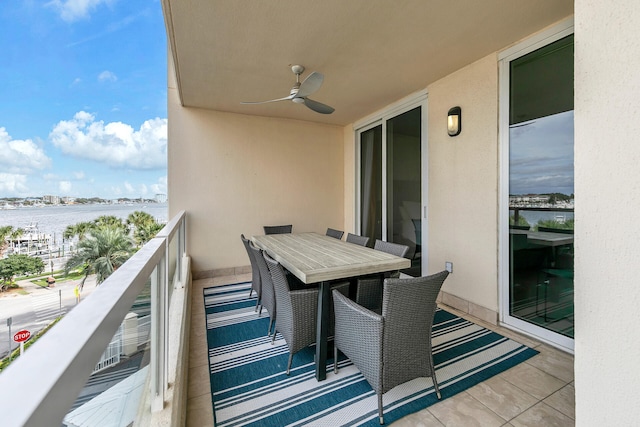 balcony with a water view and ceiling fan