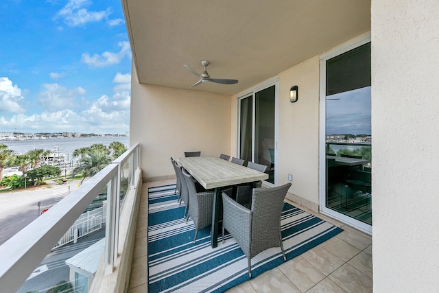 balcony featuring a water view and ceiling fan