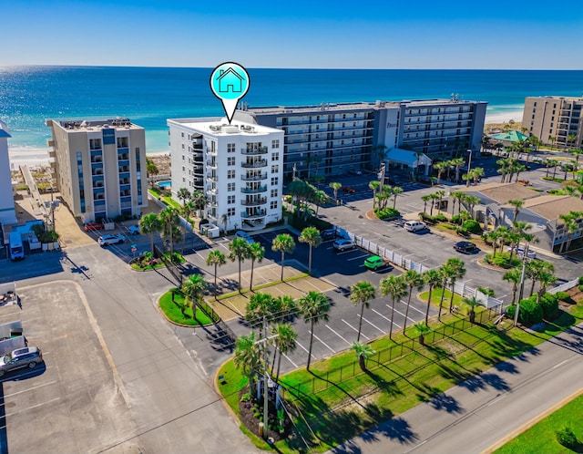 bird's eye view with a water view and a beach view