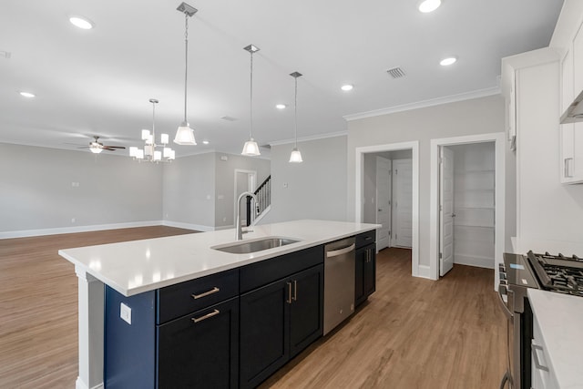 kitchen with appliances with stainless steel finishes, a kitchen island with sink, sink, light hardwood / wood-style floors, and white cabinetry