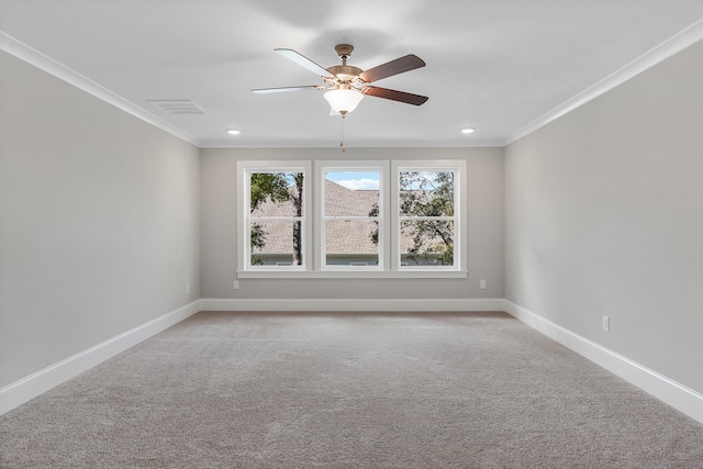 carpeted spare room featuring ceiling fan and ornamental molding