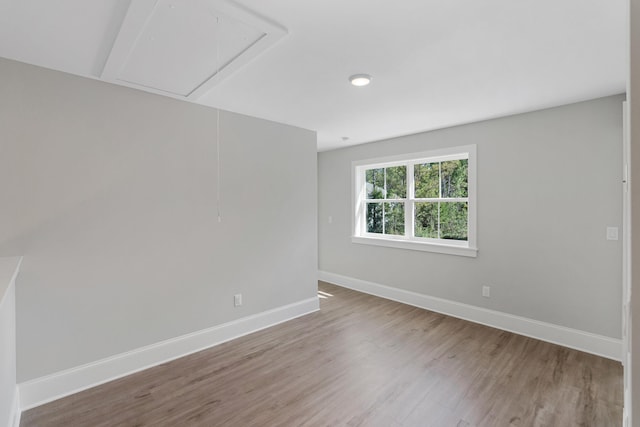 unfurnished room with wood-type flooring