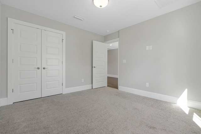 unfurnished bedroom featuring carpet and a closet