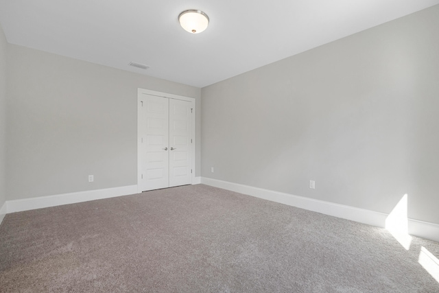 unfurnished bedroom featuring carpet and a closet