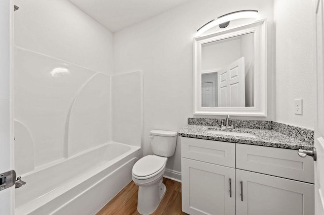 full bathroom with vanity, hardwood / wood-style flooring, toilet, and shower / bathtub combination