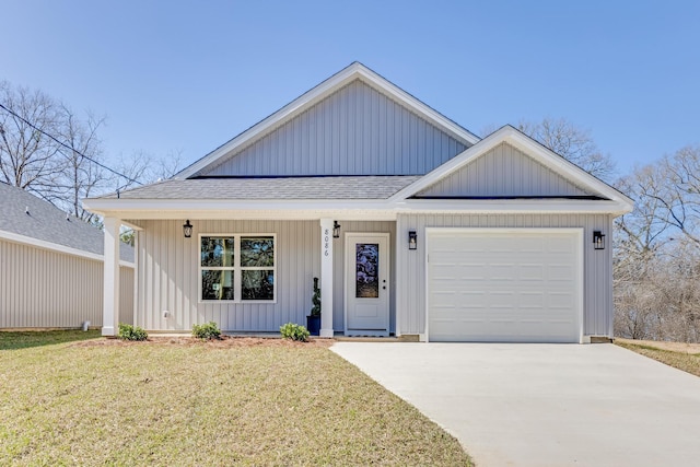 view of front of home with a garage and a front lawn