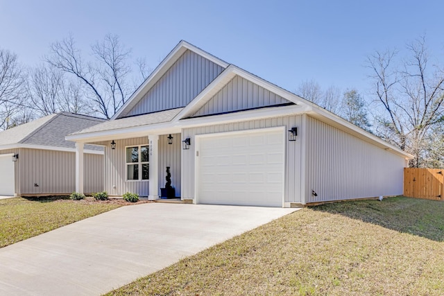 view of front of property featuring a garage, a front lawn, and covered porch