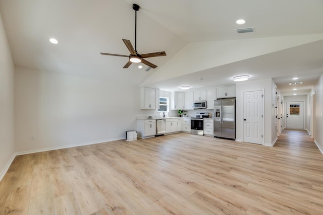 unfurnished living room featuring vaulted ceiling, sink, ceiling fan, and light hardwood / wood-style flooring