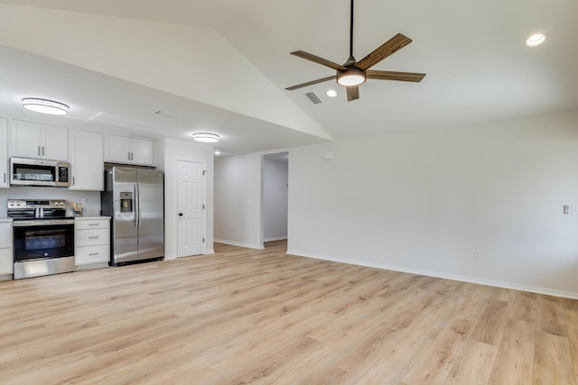 kitchen with white cabinetry, lofted ceiling, stainless steel appliances, and light wood-type flooring