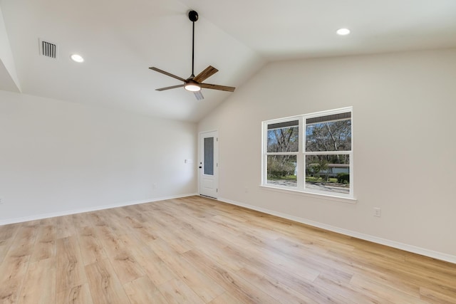 spare room with light hardwood / wood-style flooring, high vaulted ceiling, and ceiling fan