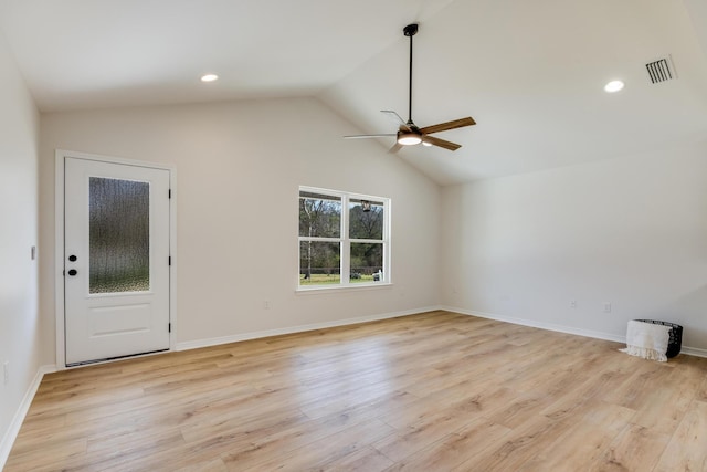 empty room featuring ceiling fan, vaulted ceiling, and light hardwood / wood-style flooring