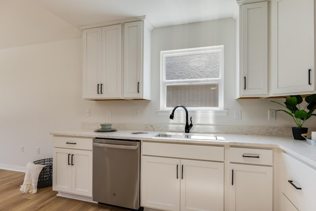 kitchen featuring white cabinetry, dishwasher, sink, and light wood-type flooring