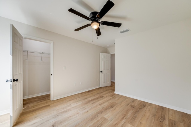 unfurnished bedroom with a closet, ceiling fan, and light wood-type flooring