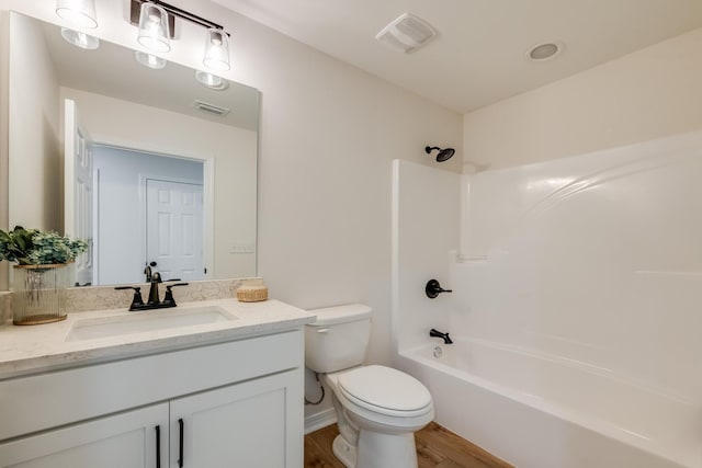 full bathroom featuring vanity, wood-type flooring, bathtub / shower combination, and toilet