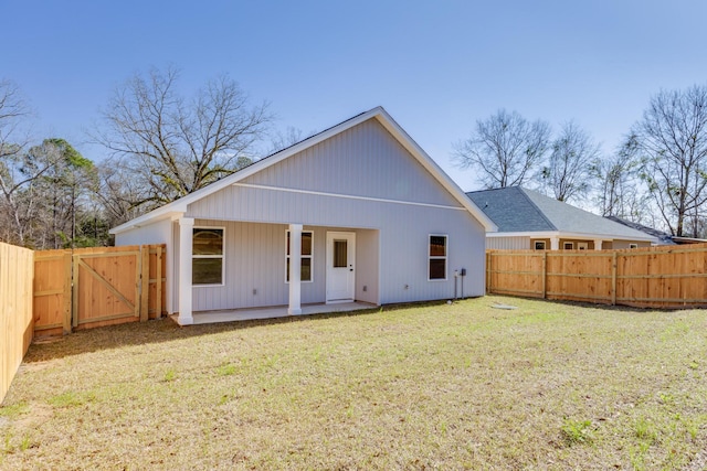 back of property featuring a yard