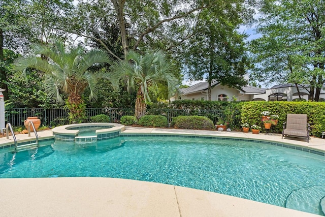 view of pool featuring an in ground hot tub