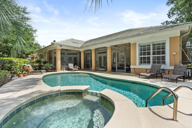 view of swimming pool featuring ceiling fan, a patio area, an in ground hot tub, and french doors