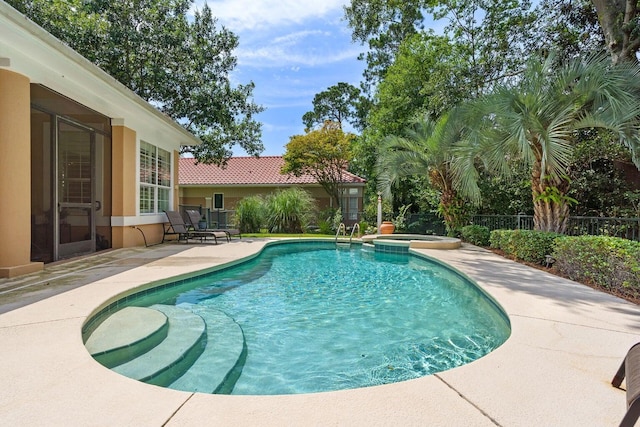 view of pool with a patio area and an in ground hot tub