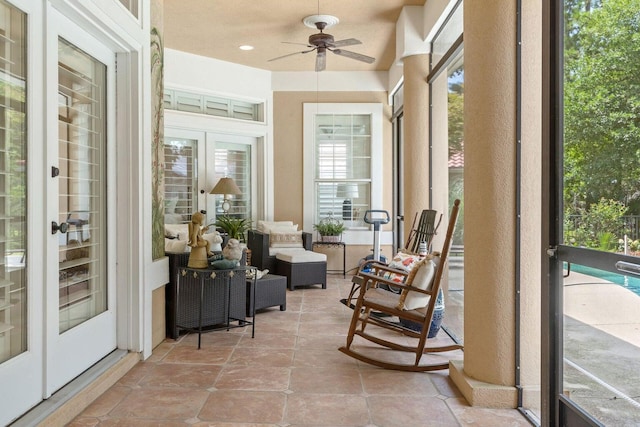 sunroom with ceiling fan and french doors