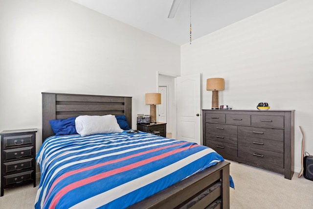 carpeted bedroom featuring high vaulted ceiling and ceiling fan