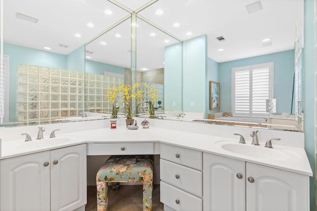 bathroom featuring a tub to relax in and vanity