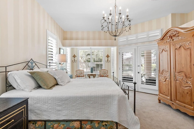 bedroom featuring an inviting chandelier, access to exterior, light carpet, and multiple windows