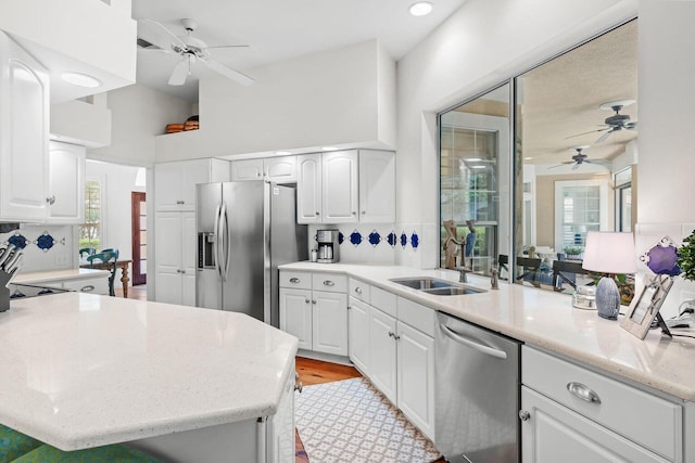 kitchen with a healthy amount of sunlight, white cabinetry, and stainless steel appliances