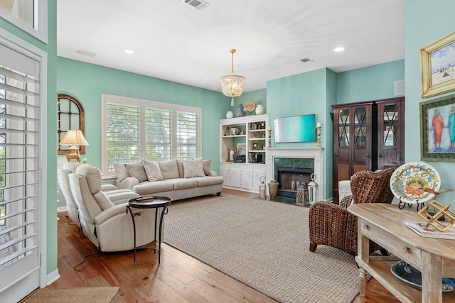 living room featuring light hardwood / wood-style flooring and a chandelier