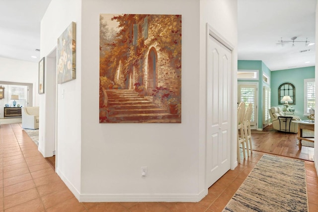 hallway with light tile patterned floors