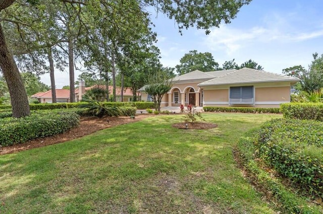 ranch-style home with a front lawn