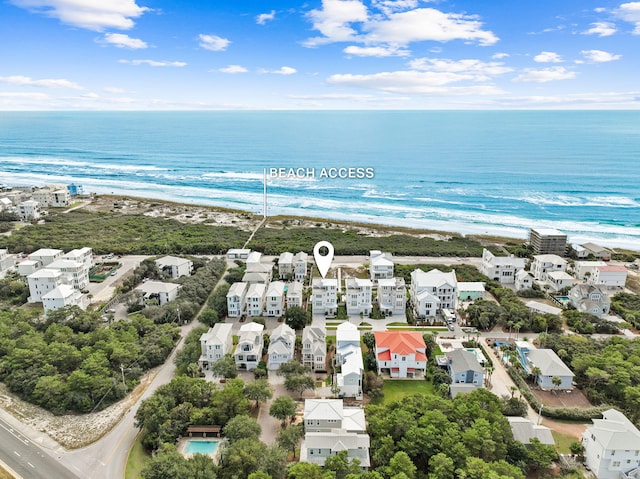 birds eye view of property with a view of the beach and a water view