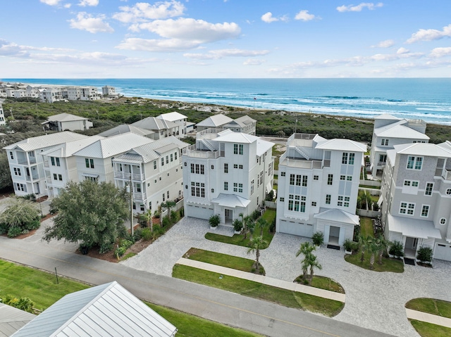 drone / aerial view featuring a water view and a view of the beach