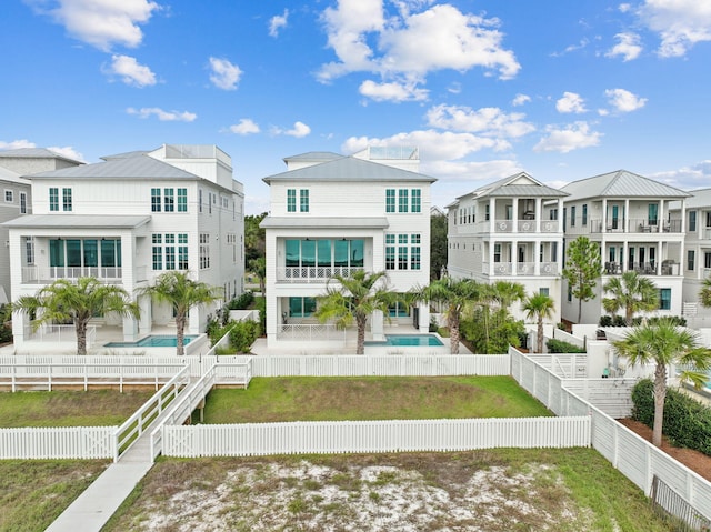 back of property featuring a fenced in pool