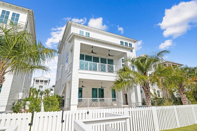 view of front of property with a balcony and ceiling fan