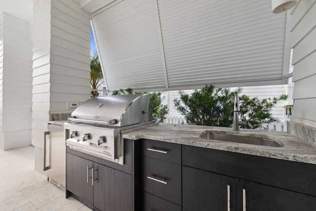 view of patio featuring area for grilling, sink, and grilling area