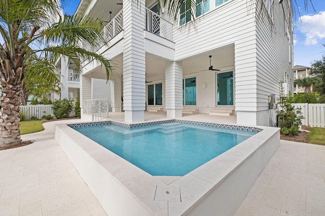 view of swimming pool featuring ceiling fan and a patio