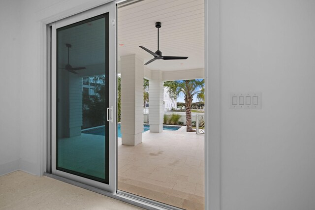 doorway to property with a fenced in pool, ceiling fan, and a patio