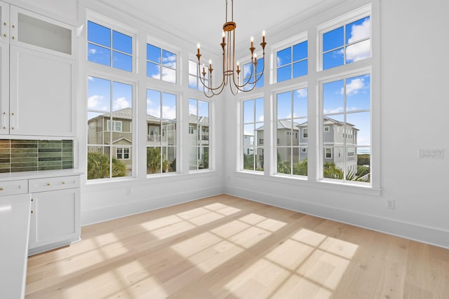 unfurnished sunroom featuring a notable chandelier