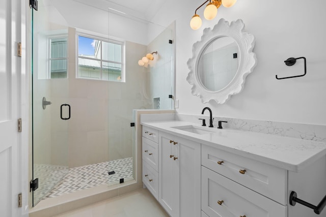 bathroom with tile patterned floors, vanity, and a shower with door