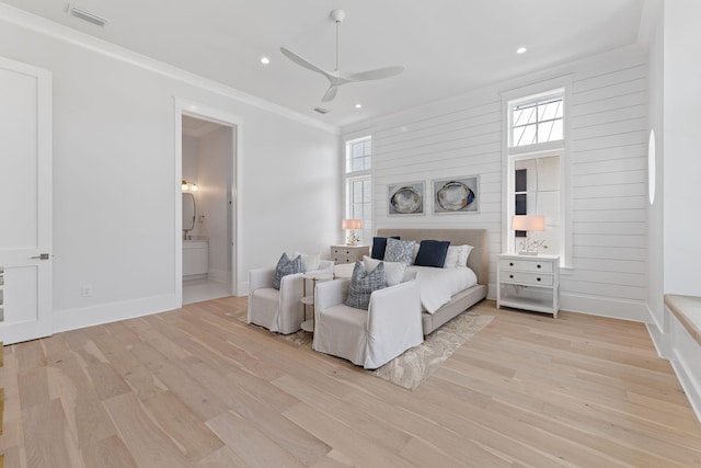 bedroom with ceiling fan, ensuite bath, ornamental molding, and light hardwood / wood-style flooring