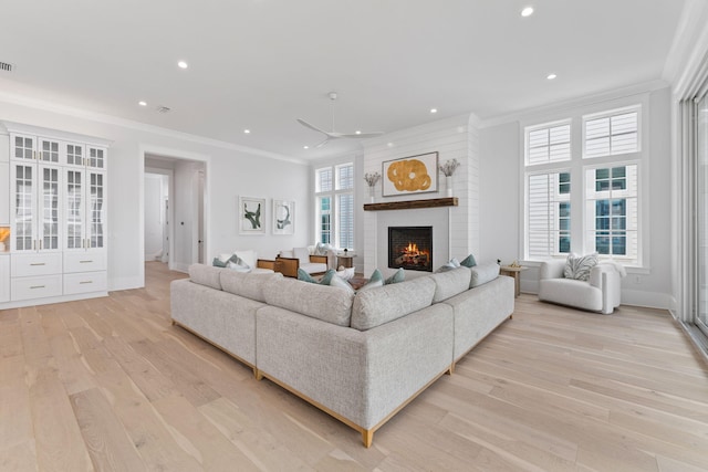 living room featuring ceiling fan, light hardwood / wood-style flooring, and ornamental molding