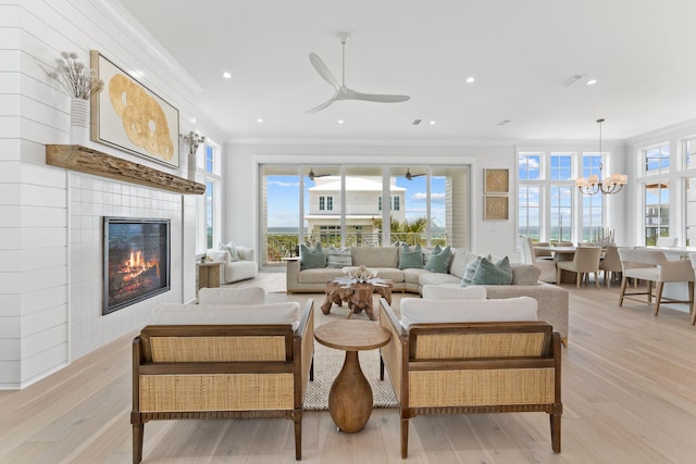 living room featuring ornamental molding, a healthy amount of sunlight, and light hardwood / wood-style floors