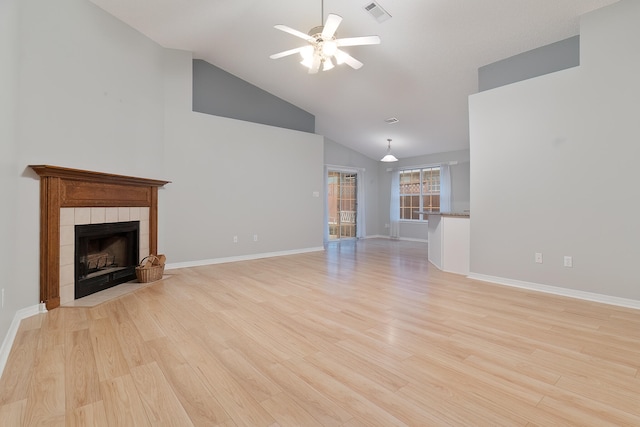 unfurnished living room with a fireplace, high vaulted ceiling, ceiling fan, and light hardwood / wood-style floors