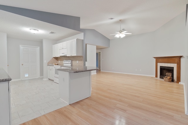 kitchen featuring light hardwood / wood-style flooring, white cabinets, vaulted ceiling, white range with electric stovetop, and kitchen peninsula