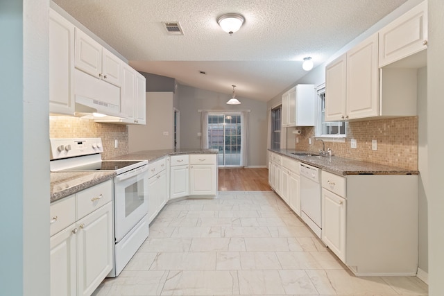 kitchen featuring white appliances, white cabinetry, hanging light fixtures, and lofted ceiling