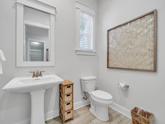 bathroom featuring hardwood / wood-style flooring, toilet, and sink