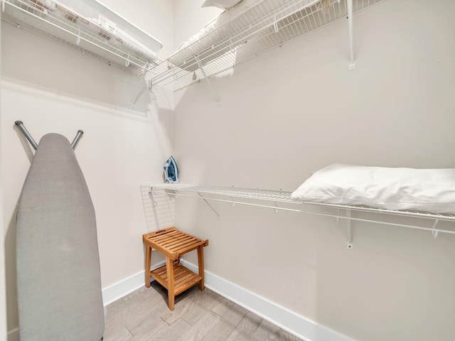 spacious closet with light hardwood / wood-style floors